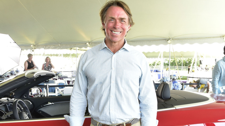 John Besh standing by car