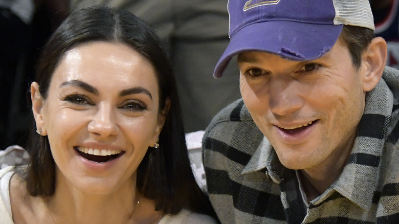 Mila Kunis and Ashton Kutcher sitting