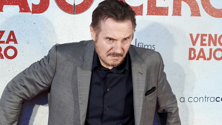 Liam Neeson posing in a menacing way