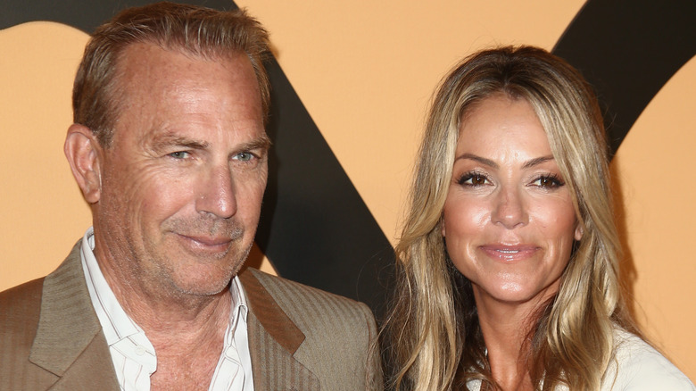 Kevin Costner and Christine Baumgartner posing