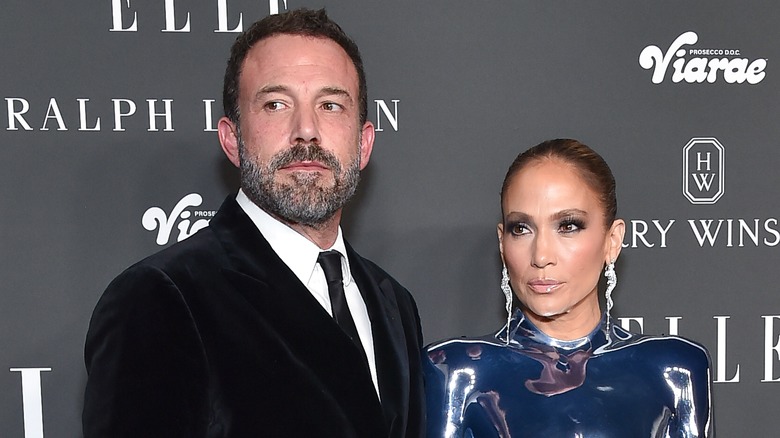 Ben Affleck and Jennifer Lopez looking away from the camera with serious expressions