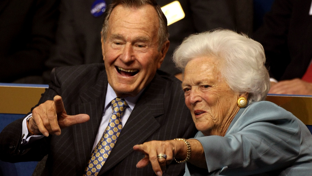 George H.W. and Barbara Bush pointing