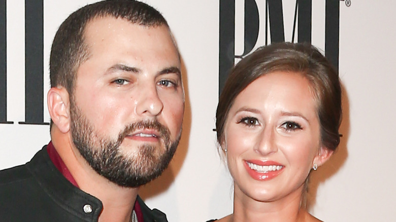 Tyler Farr and his wife at an event, smiling