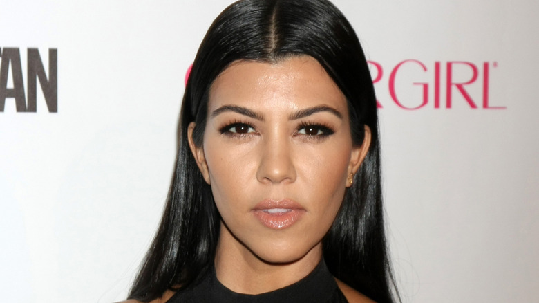 Kourtney Kardashian posing at event