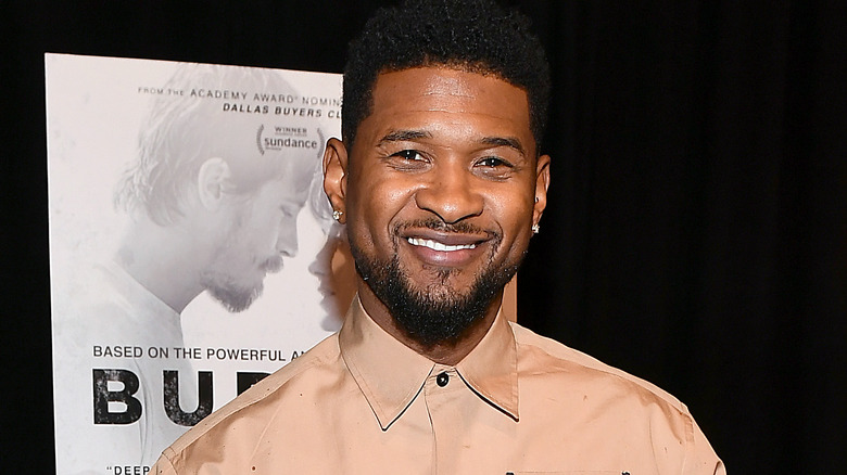 Usher smiling at event