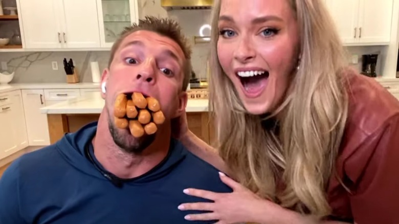 Rob Gronkowski mouth full of hot dogs with Camille Kostek