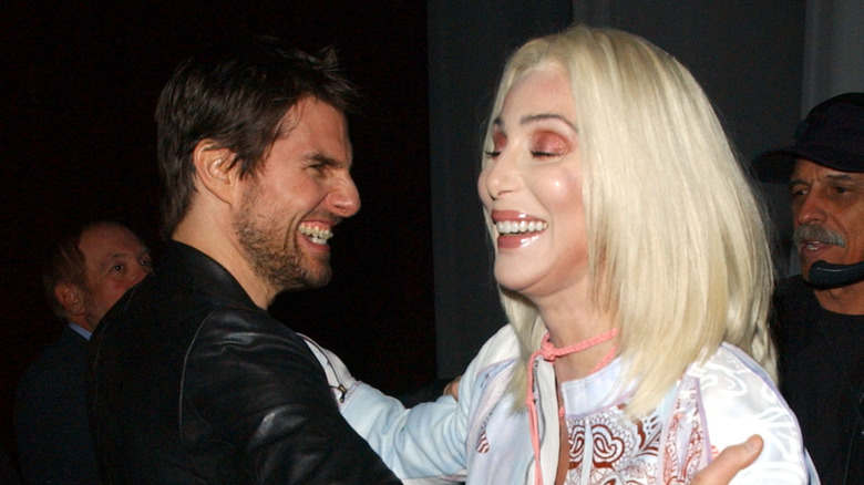 Tom Cruise and Cher laughing and hugging