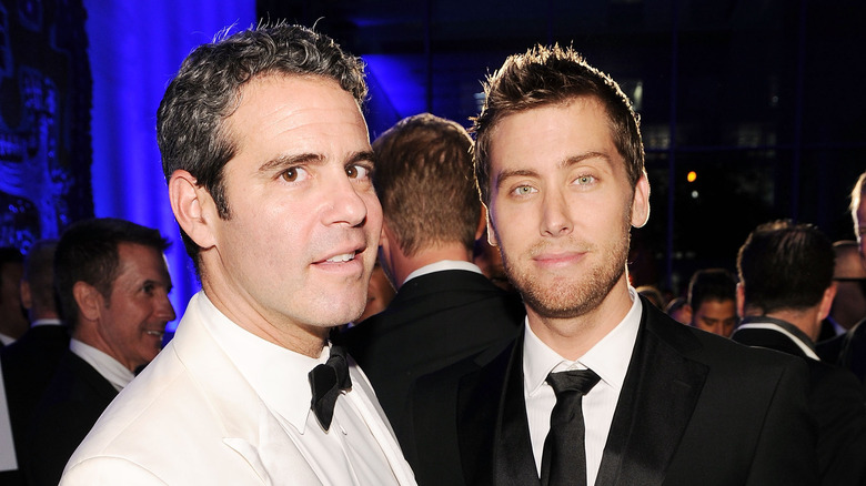 Andy Cohen and Lance Bass posing at a party