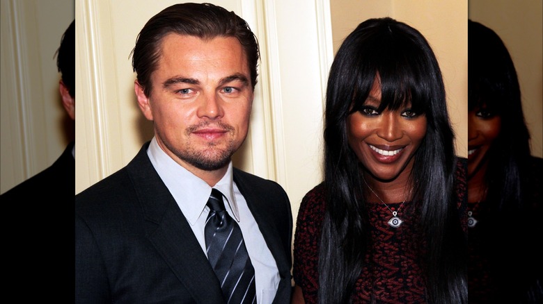 Leonardo DiCaprio posing next to a smiling Naomi Campbell 