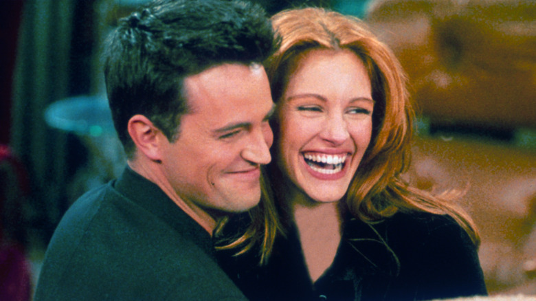 Matthew Perry and Julia Roberts smiling and embracing