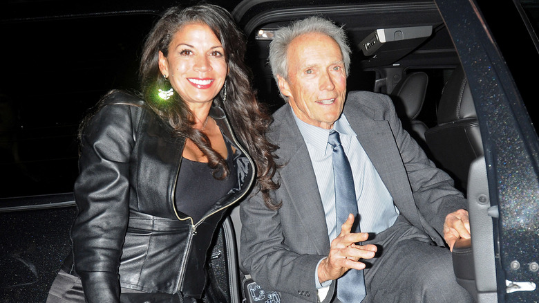 Dina Eastwood and Clint Eastwood exiting car