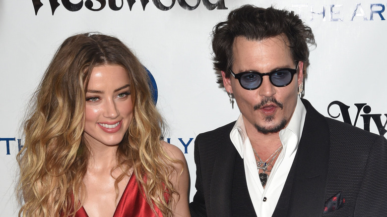 Amber Heard smiling with Johnny Depp