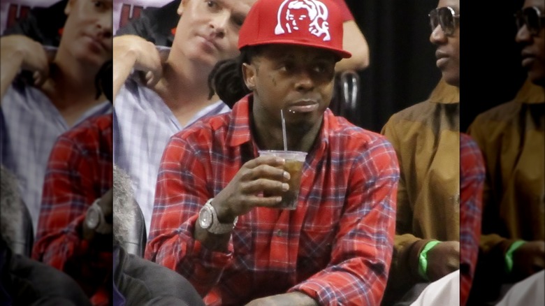 Lil Wayne holding a drink