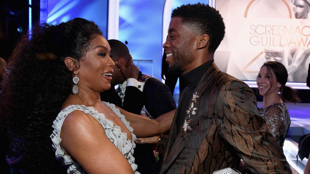 Angela Bassett and Chadwick Boseman smiling and embracing