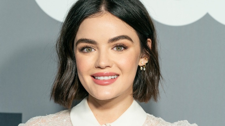 Lucy Hale smiling on a red carpet