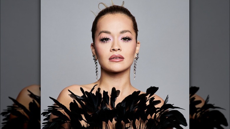 A portrait of Rita Ora in a feathery dress