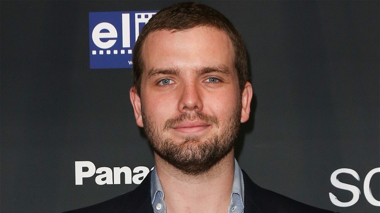 Austin Swift in front of a black background