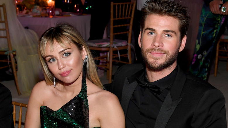 Miley Cyrus posing with Liam Hemsworth