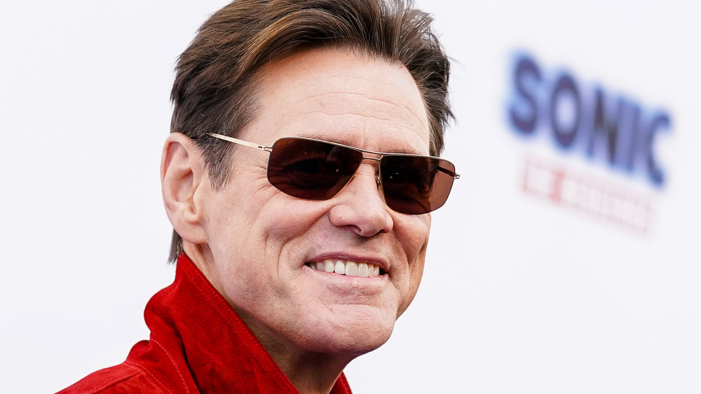 Jim Carrey smiling with sunglasses on