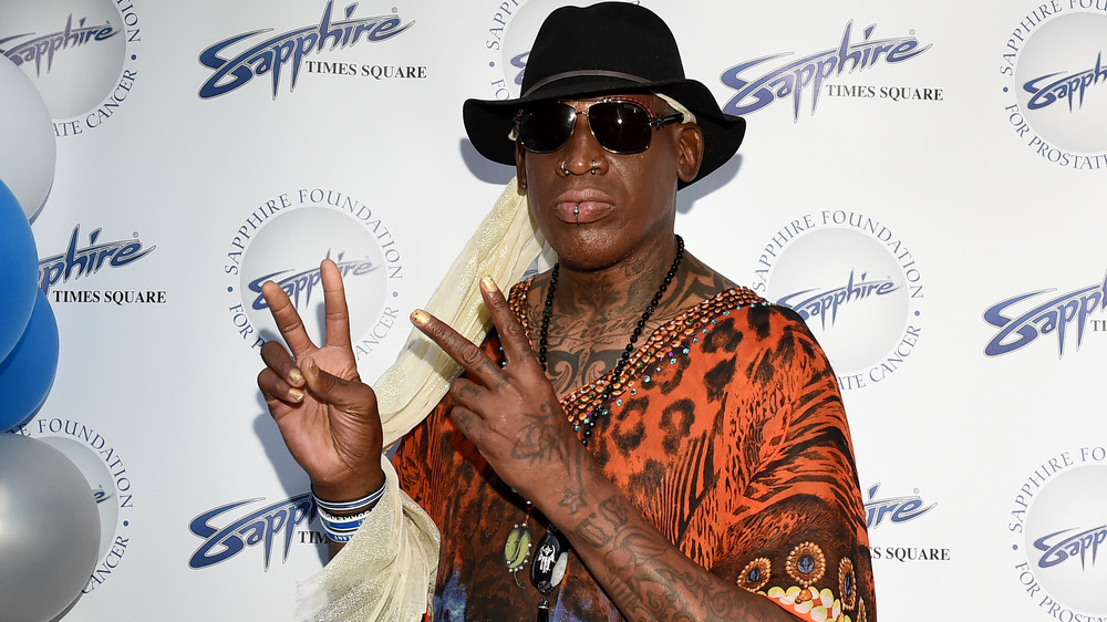 Dennis Rodman throwing up peace signs