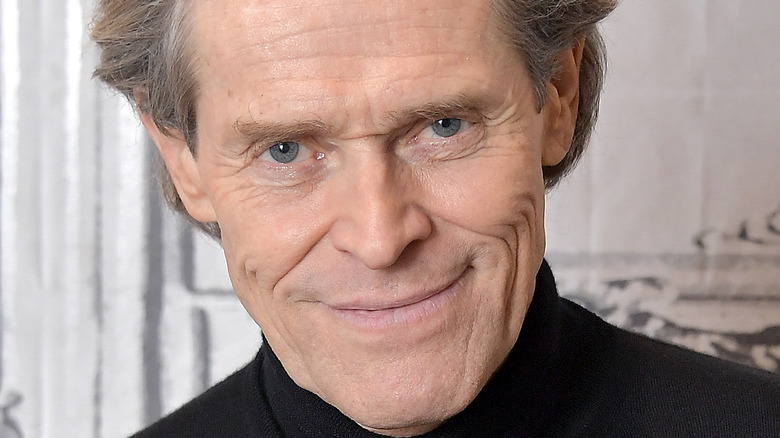 Willem Dafoe grinning 