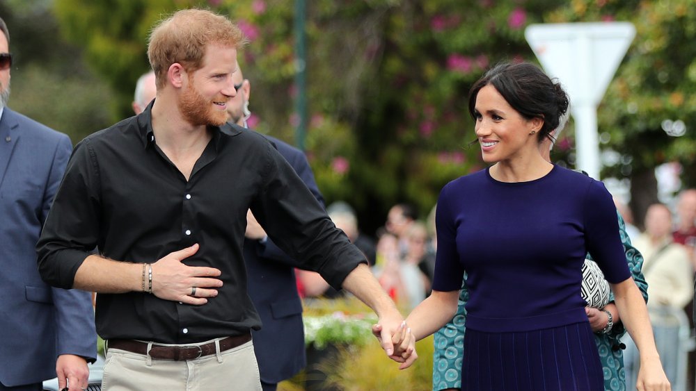 Prince Harry and Meghan Markle holding hands 