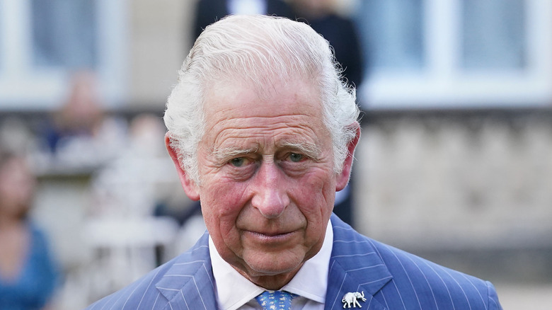 King Charles out in public wearing a blue suit