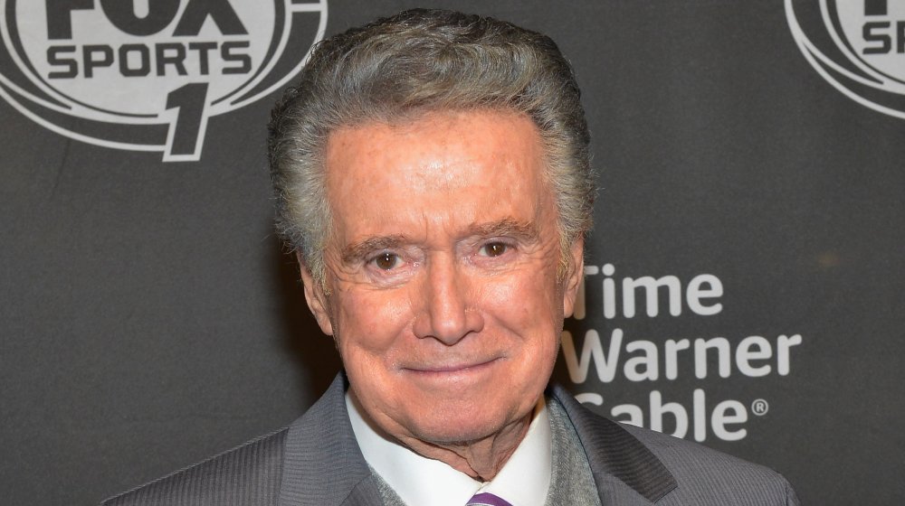 Regis Philbin in a grey suit, looking straight at the camera with a small smile