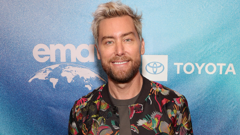 Lance Bass poses in colorful jacket