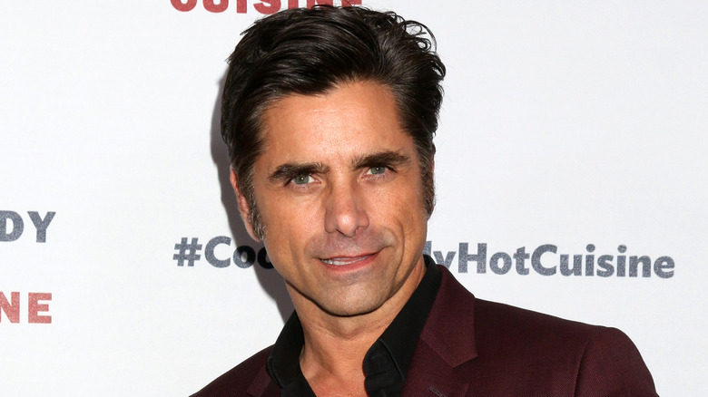 John Stamos sneering