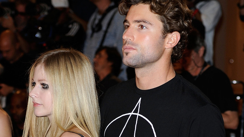 Avril Lavigne and Brody Jenner looking to the side