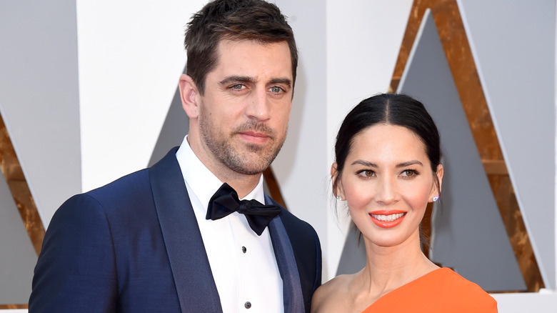 Aaron Rodgers, Olivia Munn posing