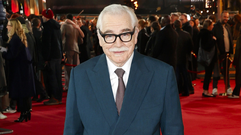 Brian Cox wearing a blue suit