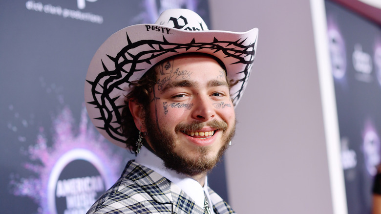 Post Malone wearing cowboy hat, smiling