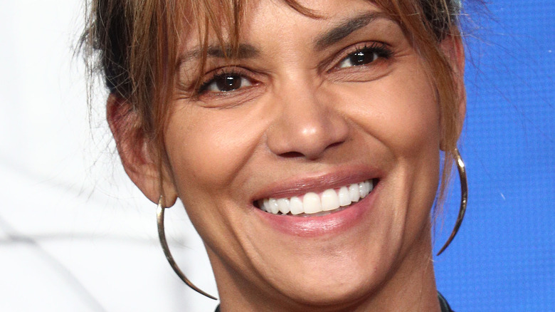 Halle Berry in front of a red wall