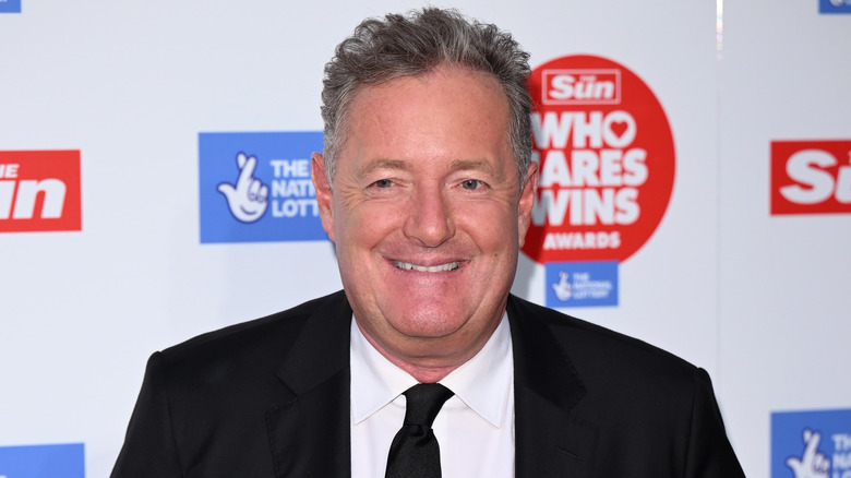 Piers Morgan smiling on red carpet