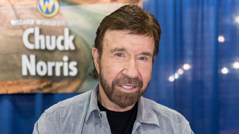 Chuck Norris signing autographs at fan convention