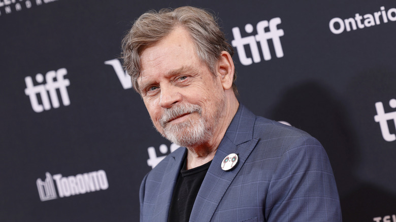 Mark Hamill posing on the red carpet at the premiere of "The Wild Robot"