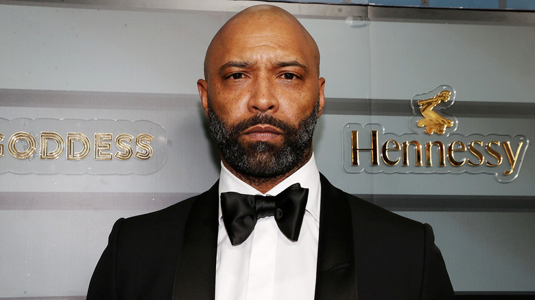 Joe Budden, posing at an event