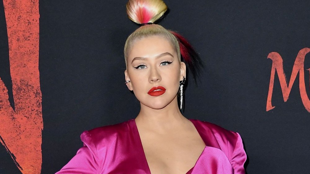 Christina Aguilera with high bun dyed red