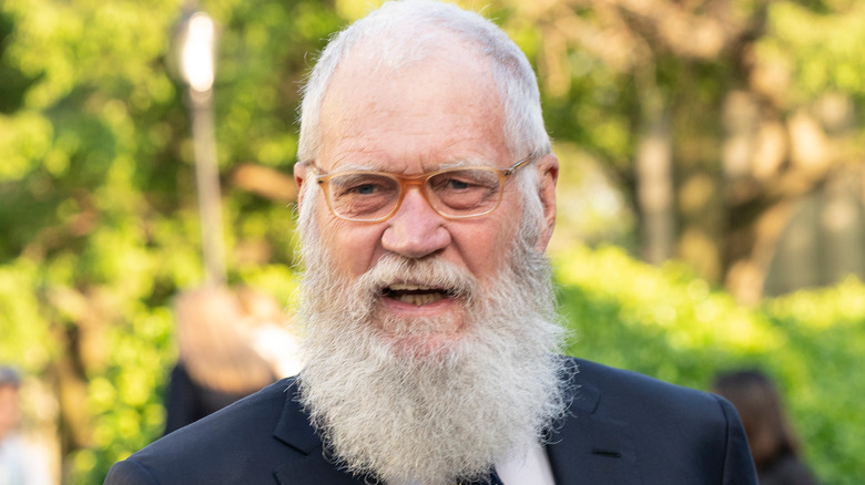 David Letterman posing for cameras, outdoors