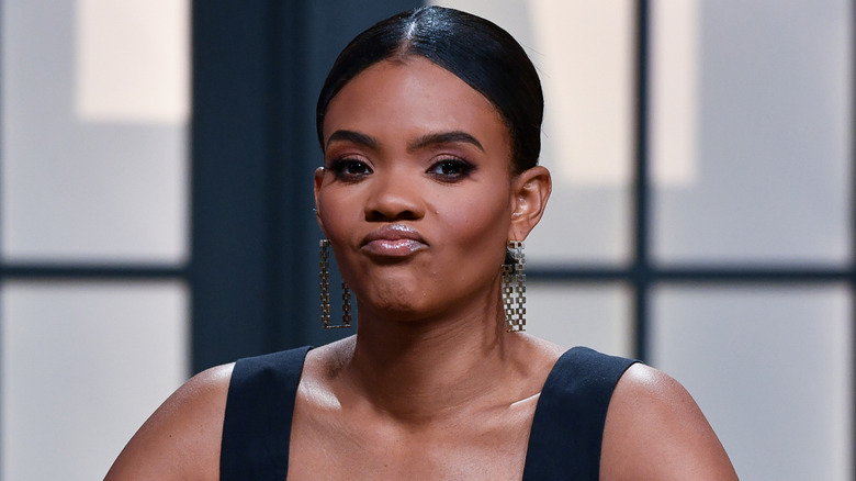 Candace Owens with pursed lips and long earrings