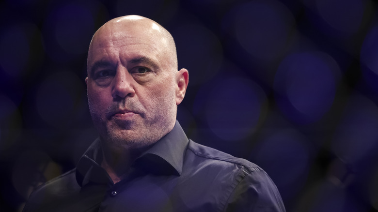 Joe Rogan wearing a collared shirt and frowning