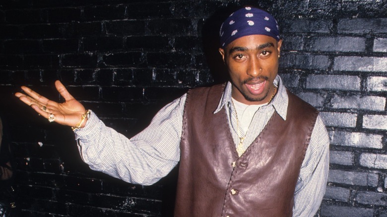 Tupac with arm extended out to side