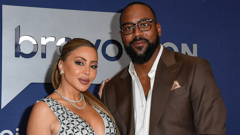 Larsa Pippen with hand on Marcus Jordan's shoulder