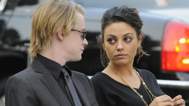 Macaulay Culkin, Mila Kunis, looking at one another