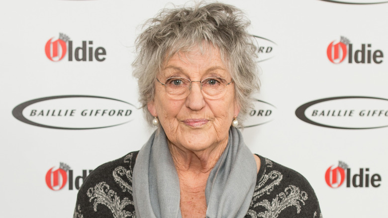 Germaine Greer wearing glasses, posing