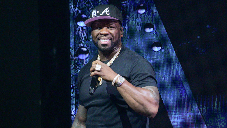 50 Cent holding microphone