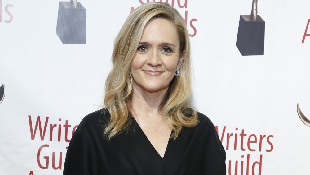 Samantha Bee with a soft smile, wearing a black outfit