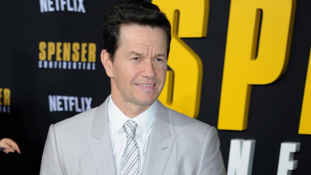 Mark Wahlberg in front of yellow, white and black wall